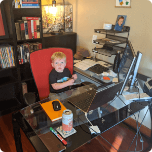 toddler sitting in front of a computer